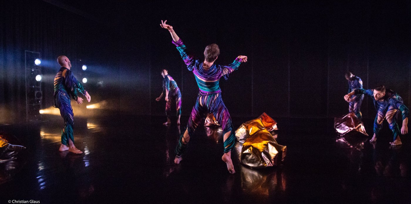 Dominik Wagner and other dancers in colorful costumes performing CORPO BAROCCO on stage